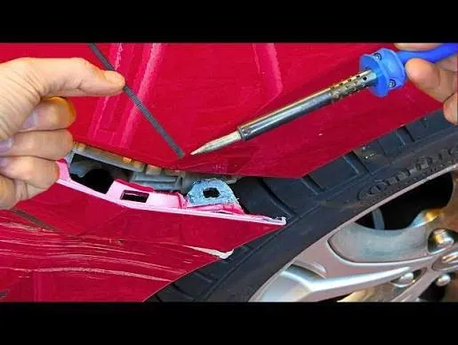 Cracked car bumper being repaired at Alibdaa Alraqi Auto Care Sharjah